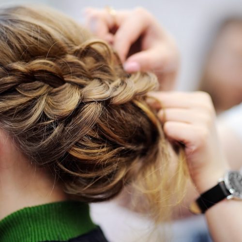 Young woman/bride getting her hair done before wedding or party